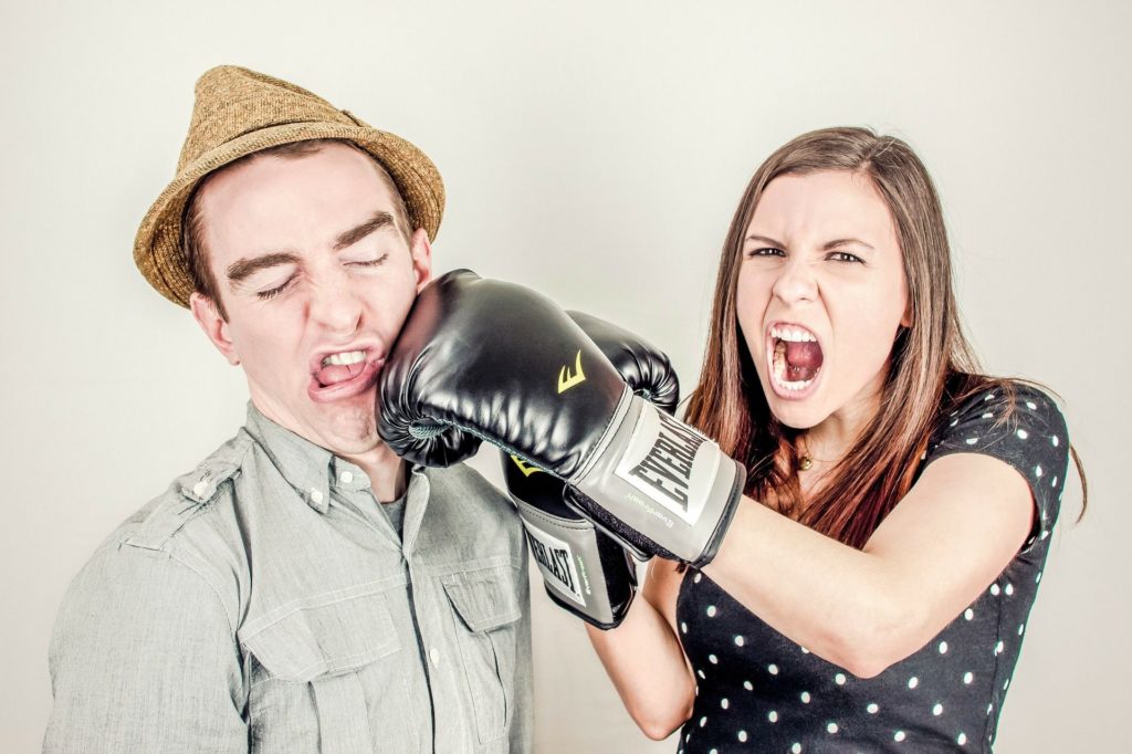 One person hitting another with boxing gloves
