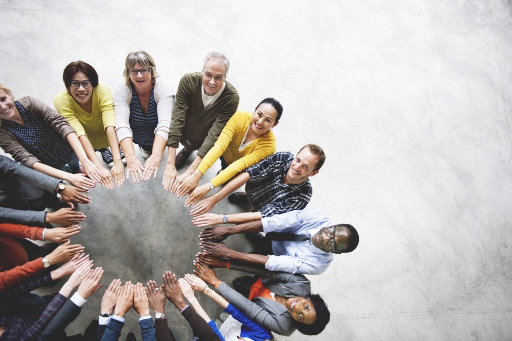 People joining hands in a circle
